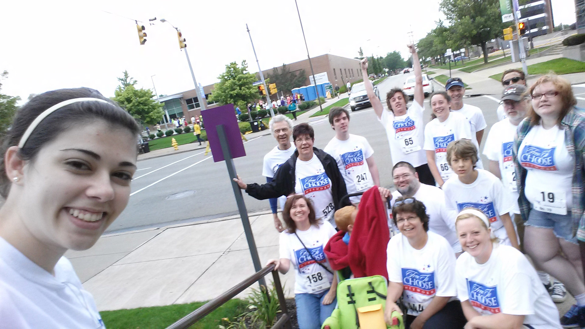 Kelsey Schupp, daughter of Free To Choose Network's COO Tara Schupp, taking a selfie with employees and family members who joined Bob in the UPMC Hamot Hospital's 10k Mayor's Cup in 2014. 